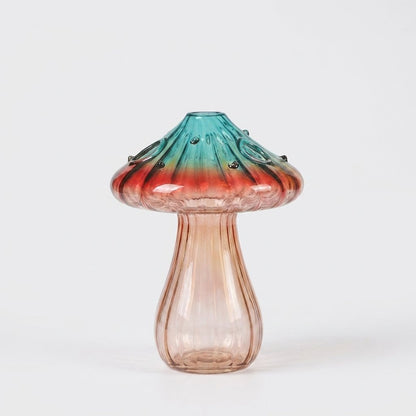 Empty Coral glass mushroom vase on a plain white studio background