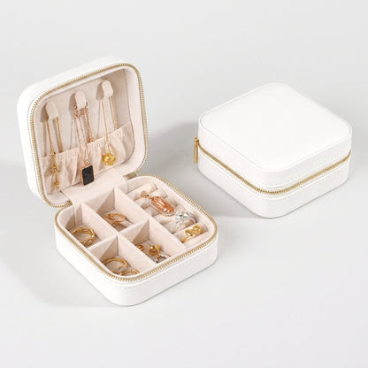 White jewelry organizer case with gold zipper hardware product photo on a white background