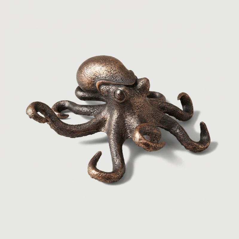Bronze octopus decorative item on a light gray background