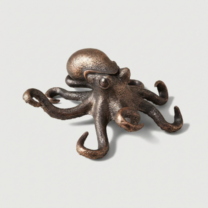 Bronze octopus decorative item on a light gray background