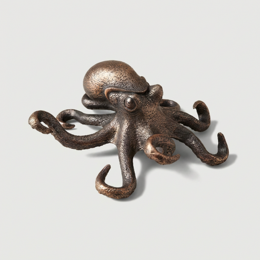 Bronze octopus decorative item on a light gray background