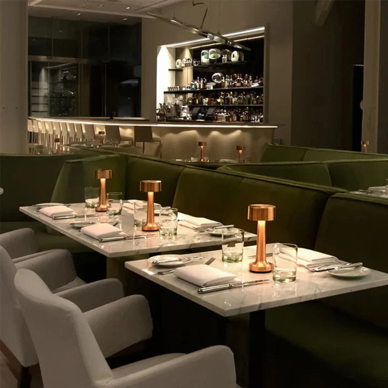 Cordless, rechargeable table lamps shown in a luxury restaurant.