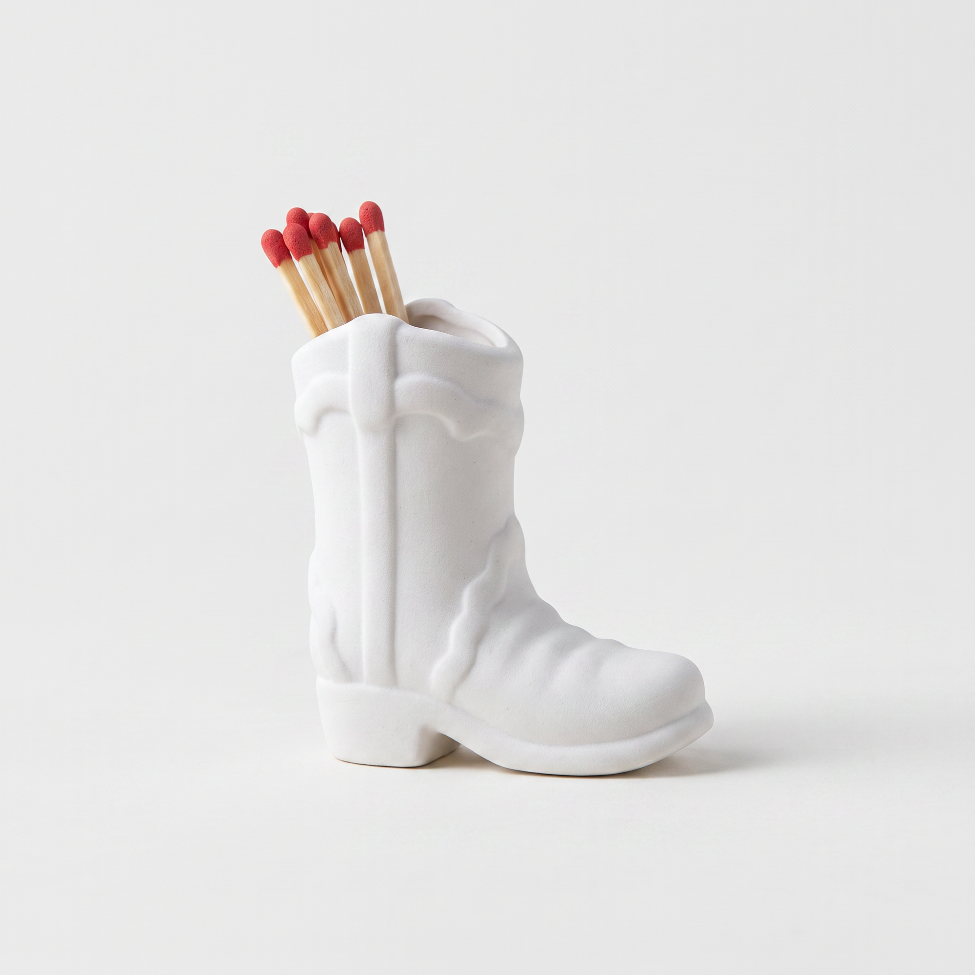 White ceramic cowboy boot match holder with matchsticks, matte finish, Kiyo Home