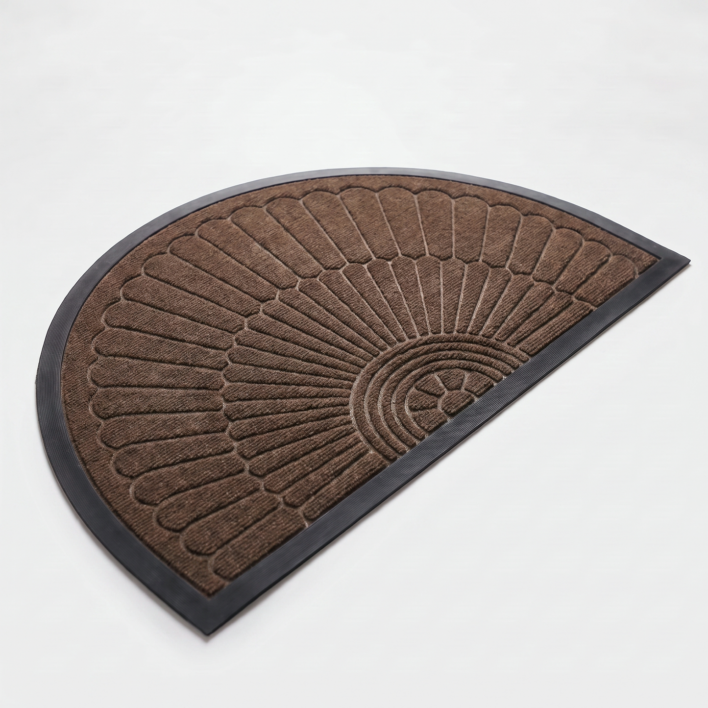 Chocolate brown crescent half-moon door mat with embossed sunburst design and black rubber border on a clean off-white background