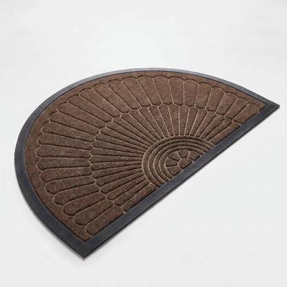 Chocolate brown crescent half-moon door mat with embossed sunburst design and black rubber border on a clean off-white background