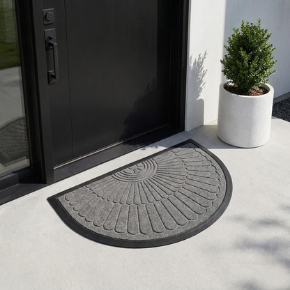 Grey crescent half-moon door mat at a modern black front door entrance