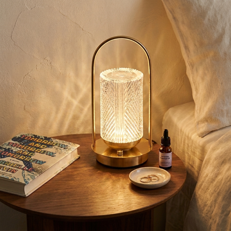Crystal touch table lamp on wooden side table beside books and diffuser