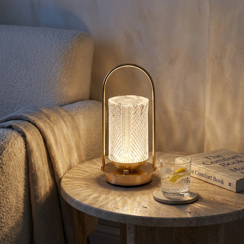 Crystal touch table lamp on armchair side table with book