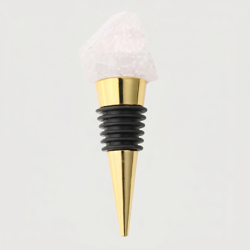 Clear quartz crystal bottle stopper with a black rubber sleeve on a light gray background
