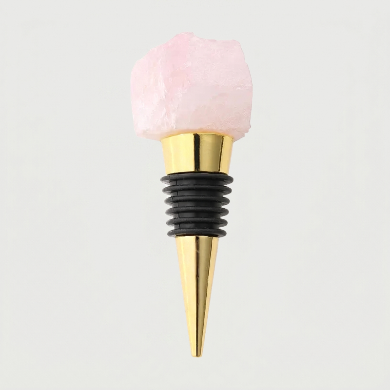 Rose quartz crystal wine bottle stopper with gold stainless steel stopper on a light gray background