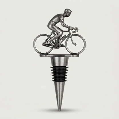 Metallic wine bottle stopper shaped like a cyclist on a bike against a white background