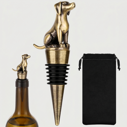 Bronze Labrador dog-shaped bottle stopper with a black pouch on a white background