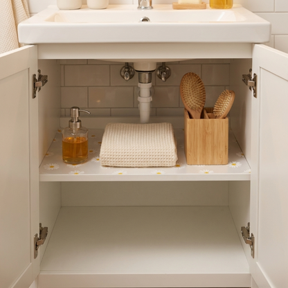 Daisy waterproof drawer liner in bathroom cabinet with bottles and towels