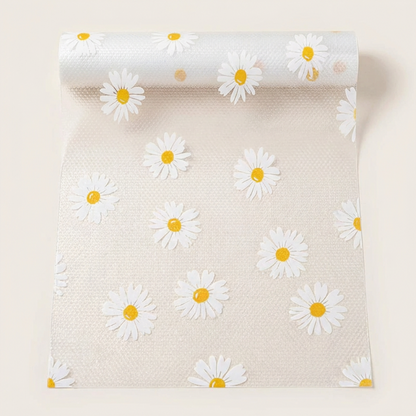 Roll of paper with white daisy flowers on a beige background