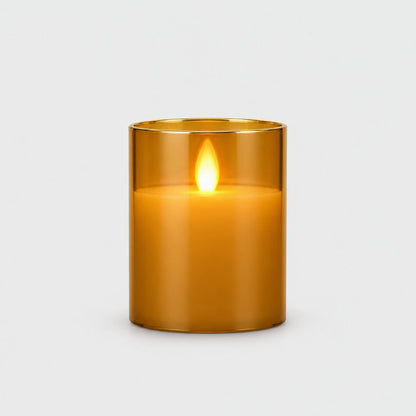 Small amber tinted flameless candle with a glowing flame on a plain light background
