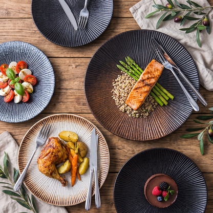 Disc ceramic dinner plates shown together in blue, gray, brown, and black