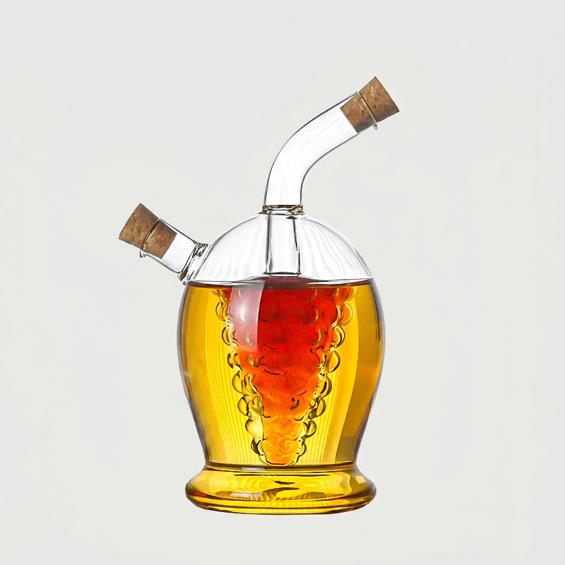 Round dual oil and vinegar bottle filled with golden oil on white background