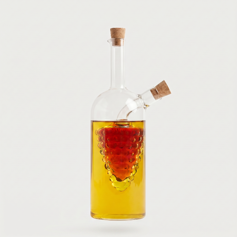 Tall dual oil and vinegar bottle on white background with amber liquid