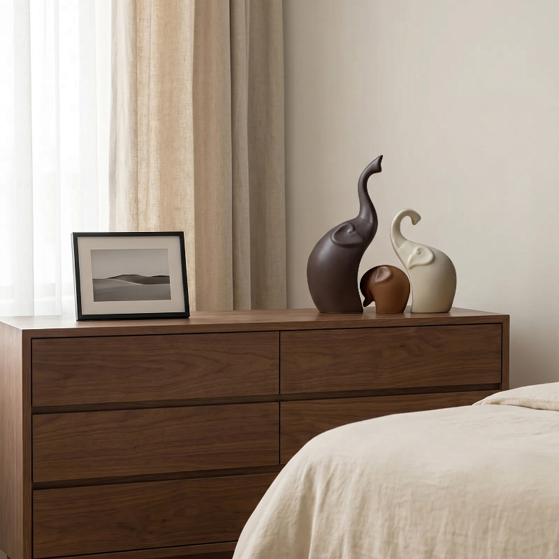 Elephant sculptures set of 3 on dresser in softly lit bedroom