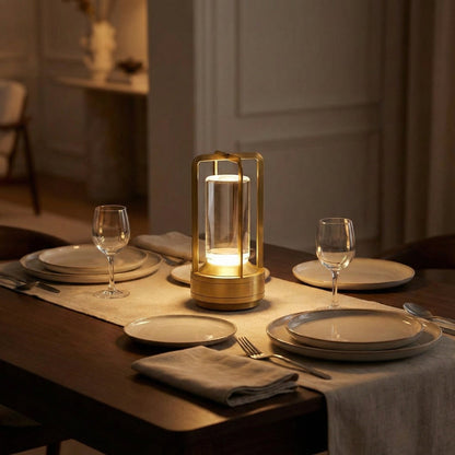 Decorative lamp on a set dining table with plates and glasses.