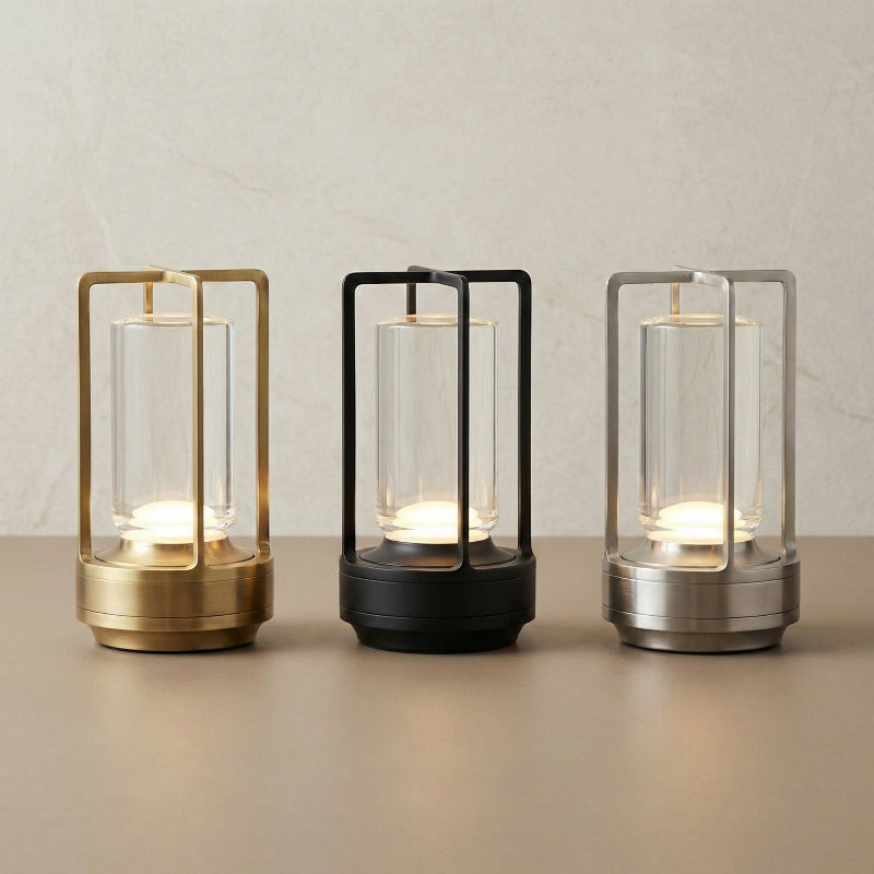 Three modern table lamps with different metallic finishes on a neutral background