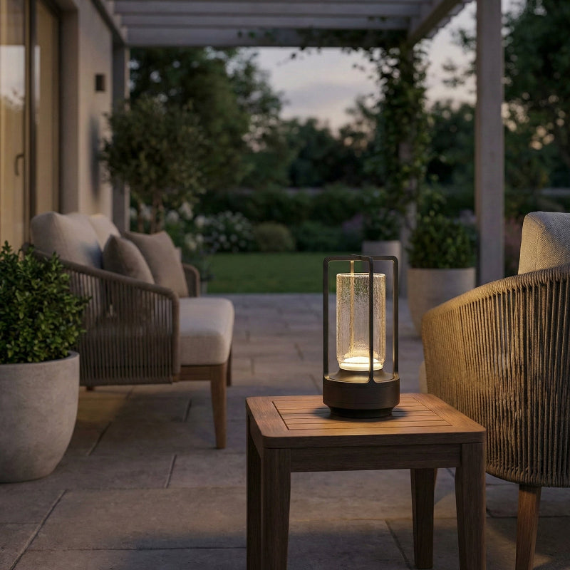 Outdoor patio setting with chairs, table, and illuminated lantern.