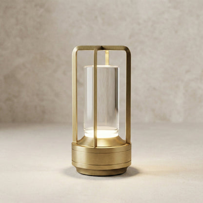 Gold table lamp with glass shade on a neutral background