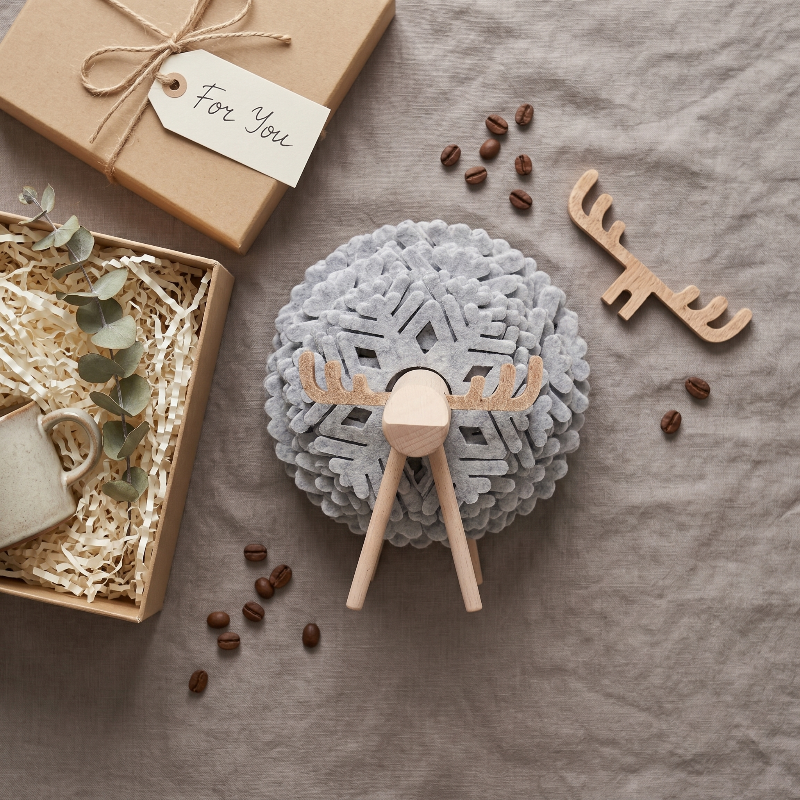 Grey elk drink coaster with coffee cup and snack on woven mat