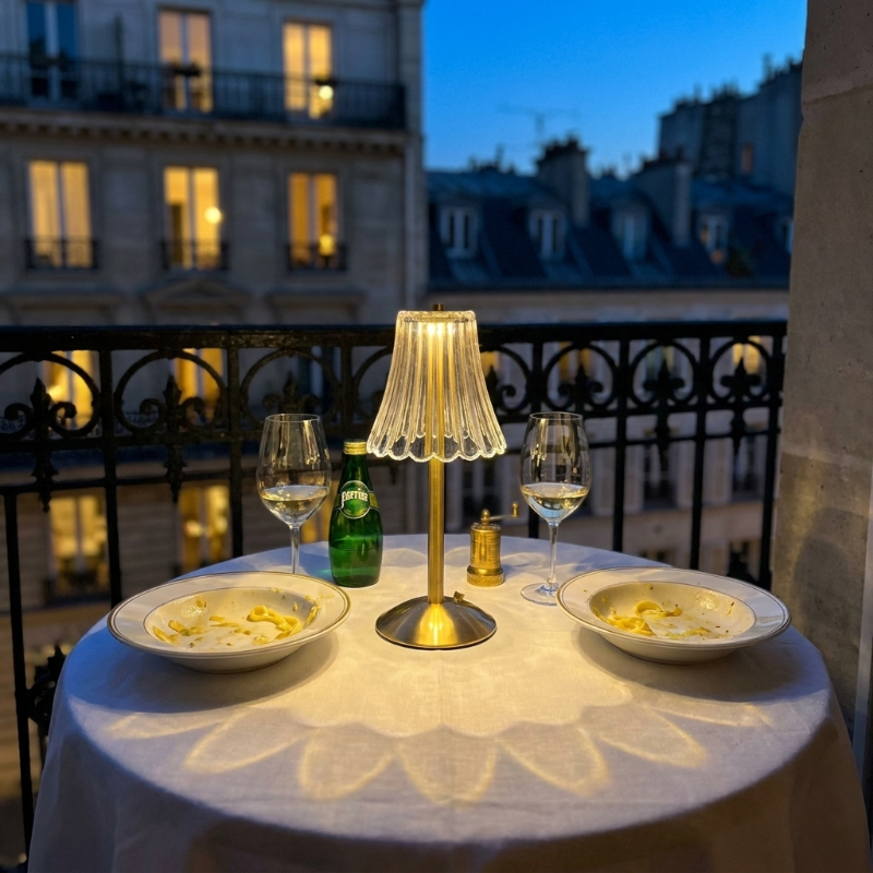 Elysian cordless dimmable table lamp on rooftop table at night