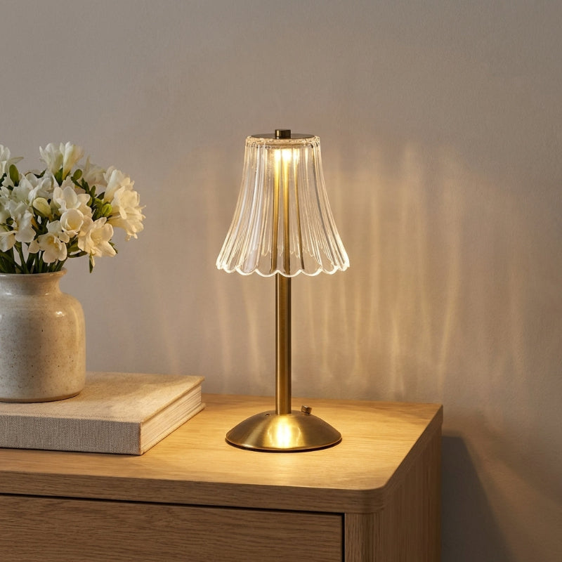 Elysian cordless dimmable table lamp on bedside table with books and vase