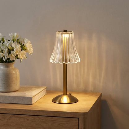 Elysian cordless dimmable table lamp on bedside table with books and vase