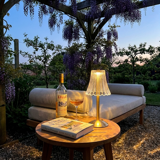Elysian cordless dimmable table lamp on outdoor side table at dusk