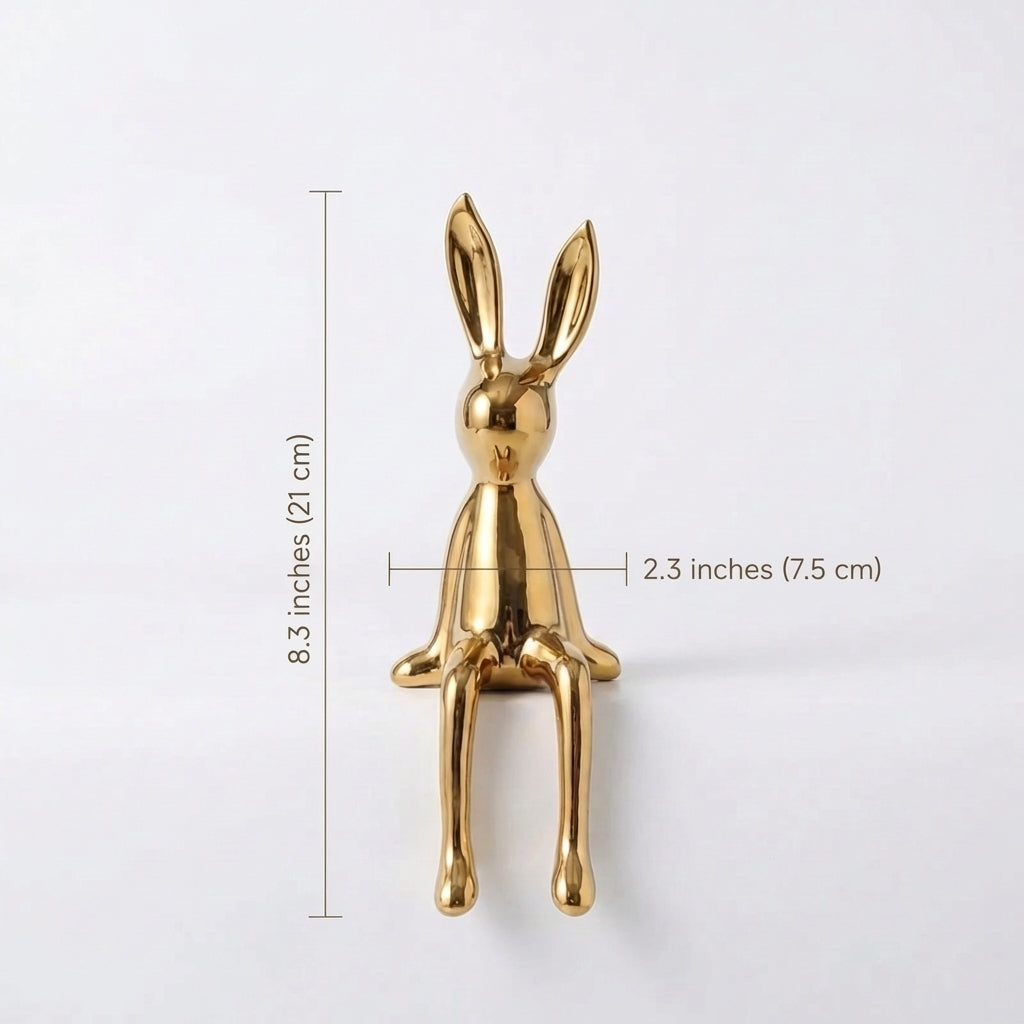 Gold rabbit-shaped object with dimensions on a white background
