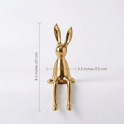 Gold rabbit-shaped object with dimensions on a white background