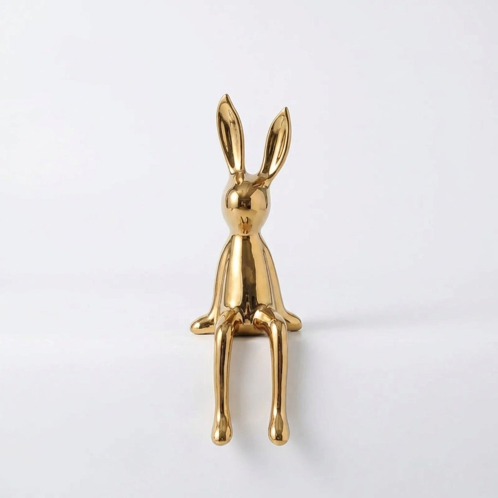 Gold rabbit-shaped object on a white background