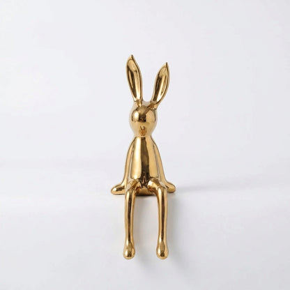 Gold rabbit-shaped object on a white background