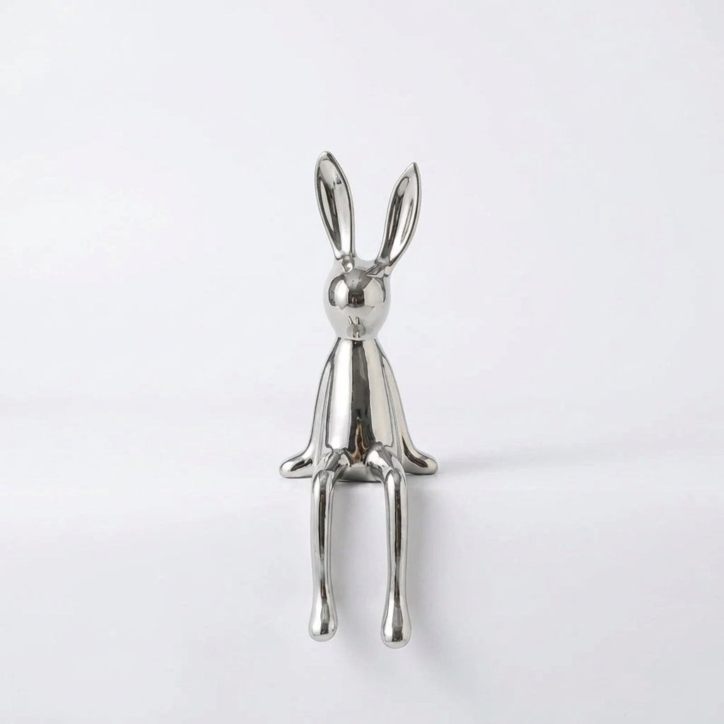 Silver rabbit-shaped object on a white background