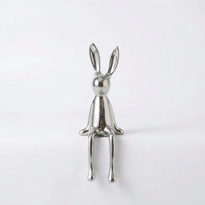 Silver rabbit-shaped object on a white background