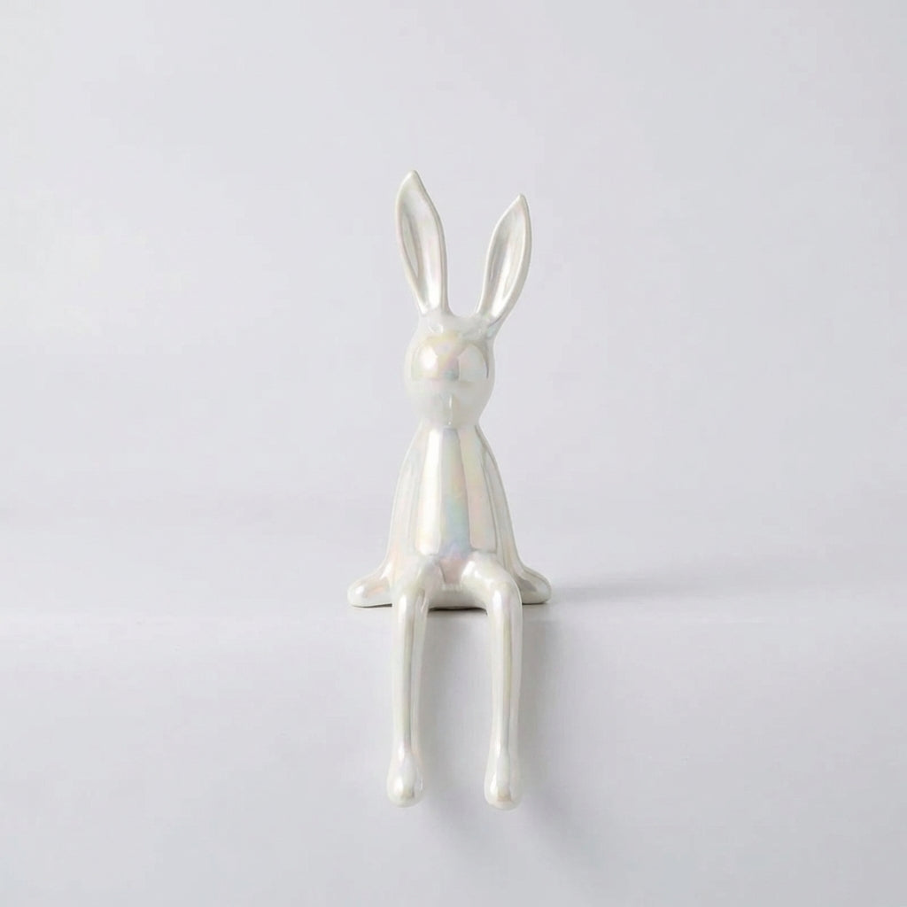 White rabbit figurine on a light gray background