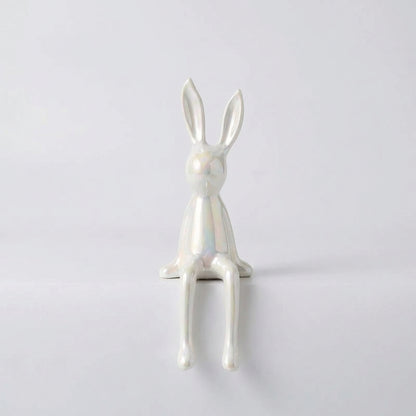 White rabbit figurine on a light gray background