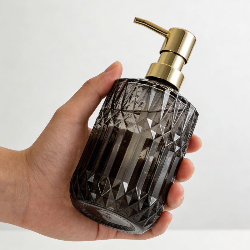 Smoke facet glass soap dispenser shown in hand