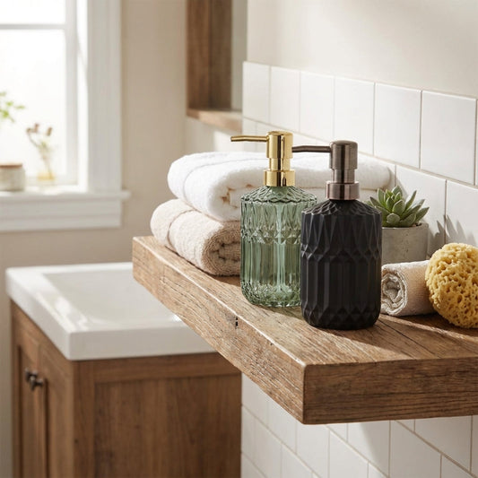 Facet glass soap dispensers on bathroom tray with towels