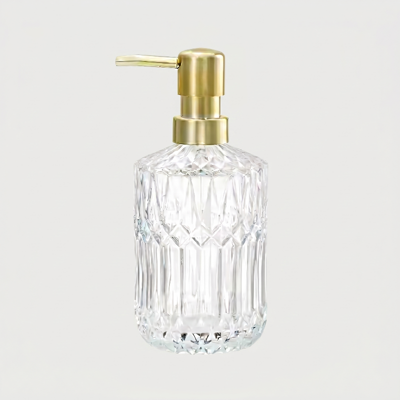 Clear facet glass soap dispenser on white background