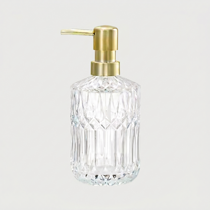 Clear facet glass soap dispenser on white background