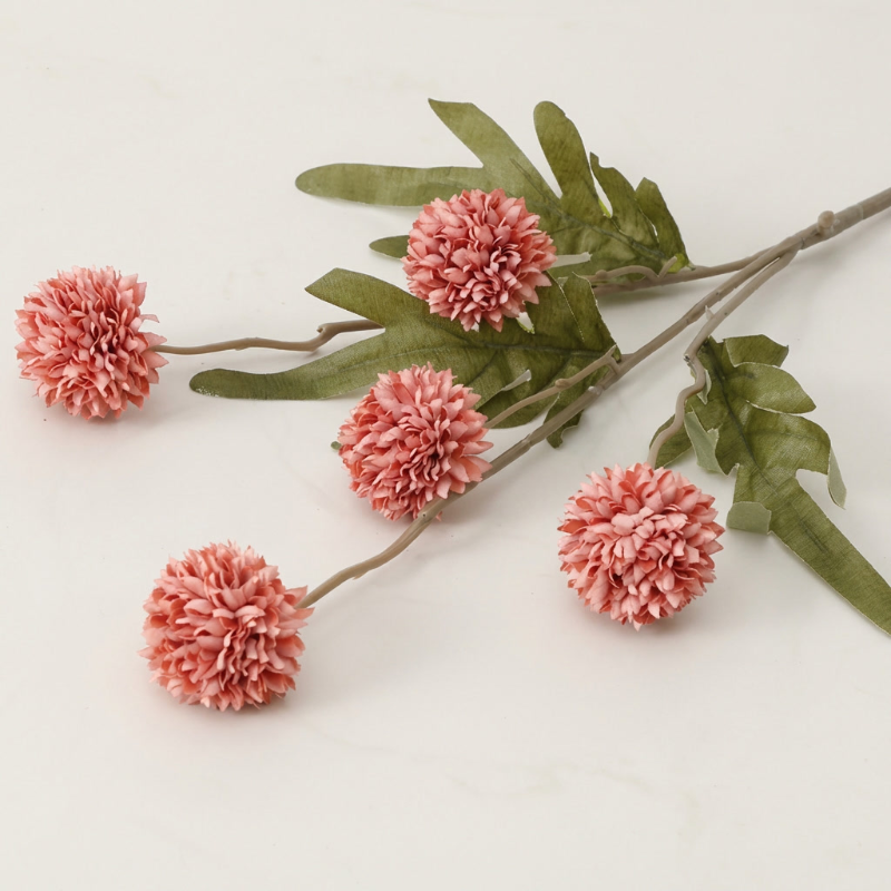 Coral faux dandelion stems on white background