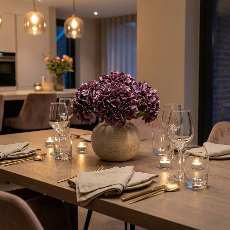 Faux hydrangea stems in vase on dining table