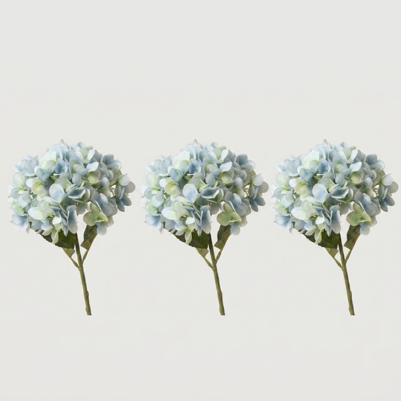 Three blue faux hydrangea stems on white background
