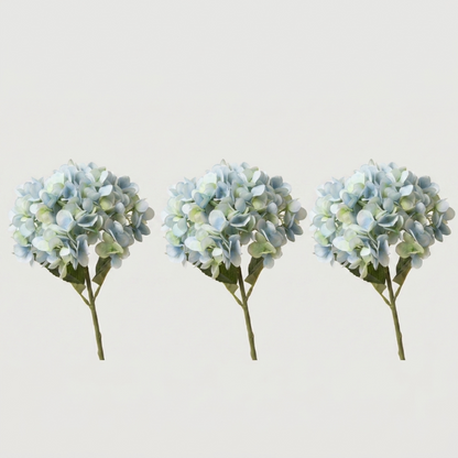 Three blue faux hydrangea stems on white background