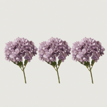 Three purple faux hydrangea stems on white background