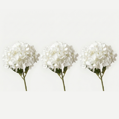 Three white faux hydrangea stems on white background